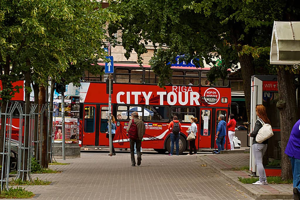 City Tour bus Riga with people standing in front of the bus
